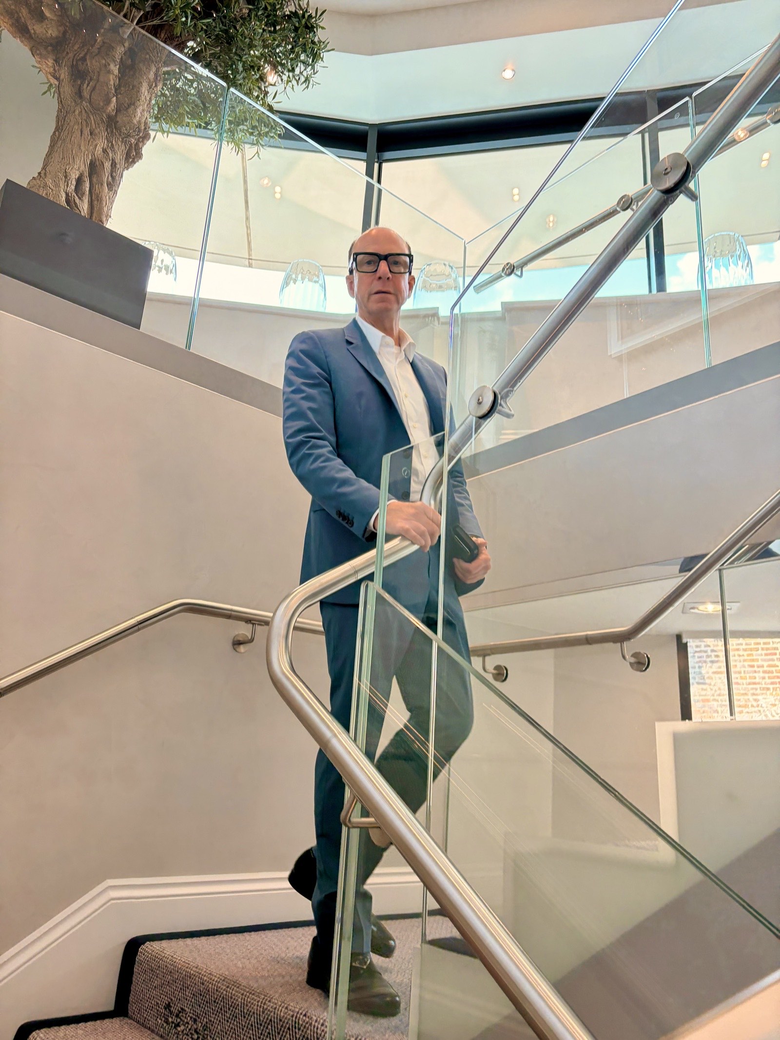 Mark Dyer Properties portfolio: Mark Dyer, property investor, on the glass staircase of a riverside development