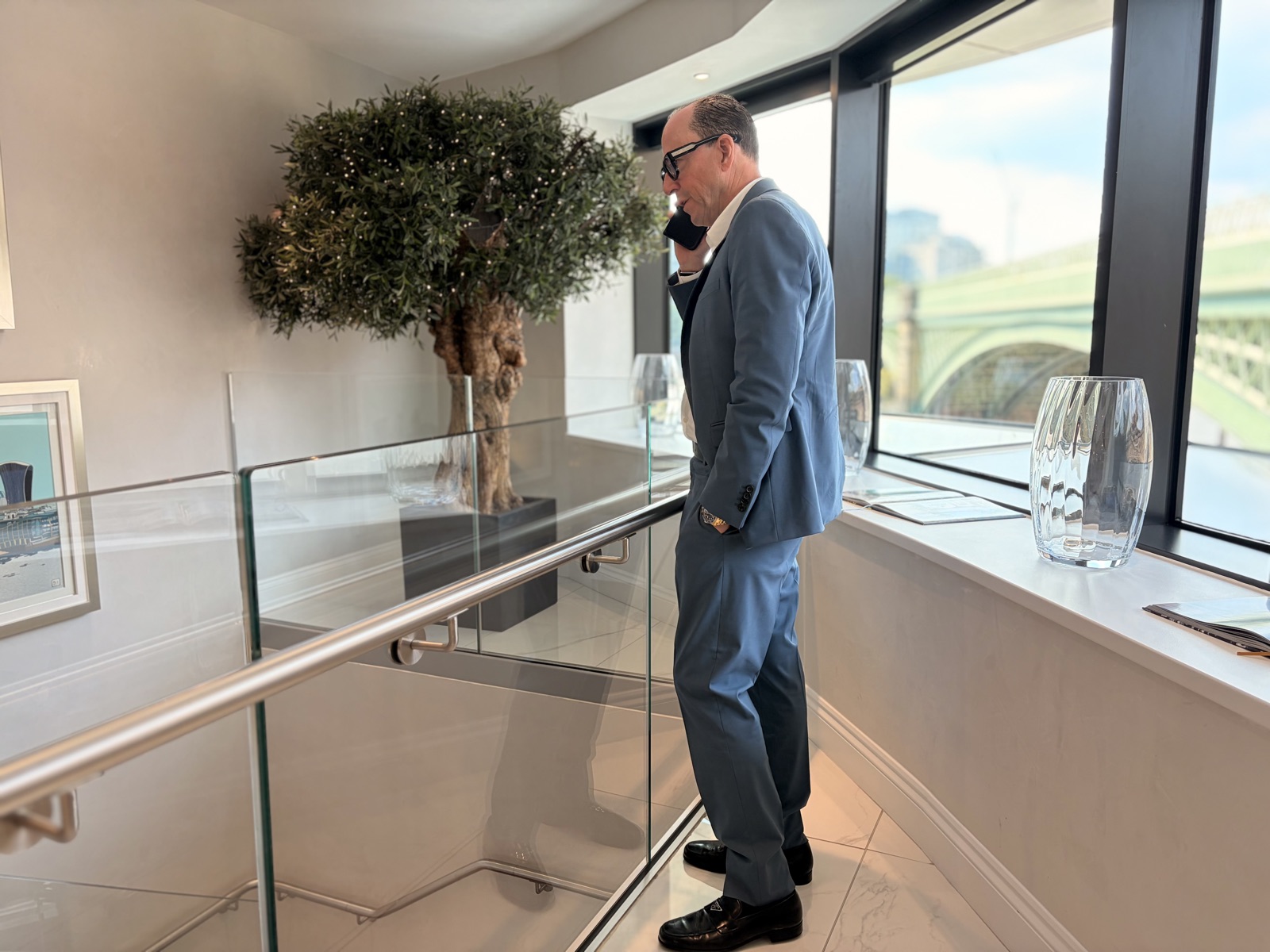 Mark Dyer Hacking Trust: Mark Dyer, founder of The Hacking Trust PLC, taking a call at his riverside office